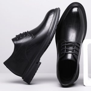 Elevator shoes with a sleek black leather finish, designed to increase height discreetly and stylishly, perfect for formal or business occasions.
