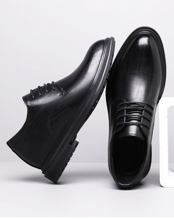 Elevator shoes with a sleek black leather finish, designed to increase height discreetly and stylishly, perfect for formal or business occasions.